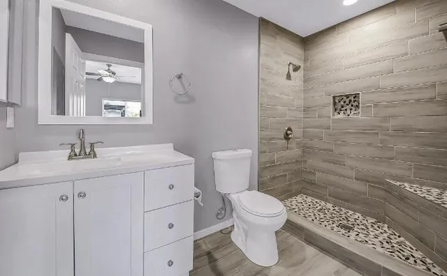 a bathroom with a sink toilet and shower