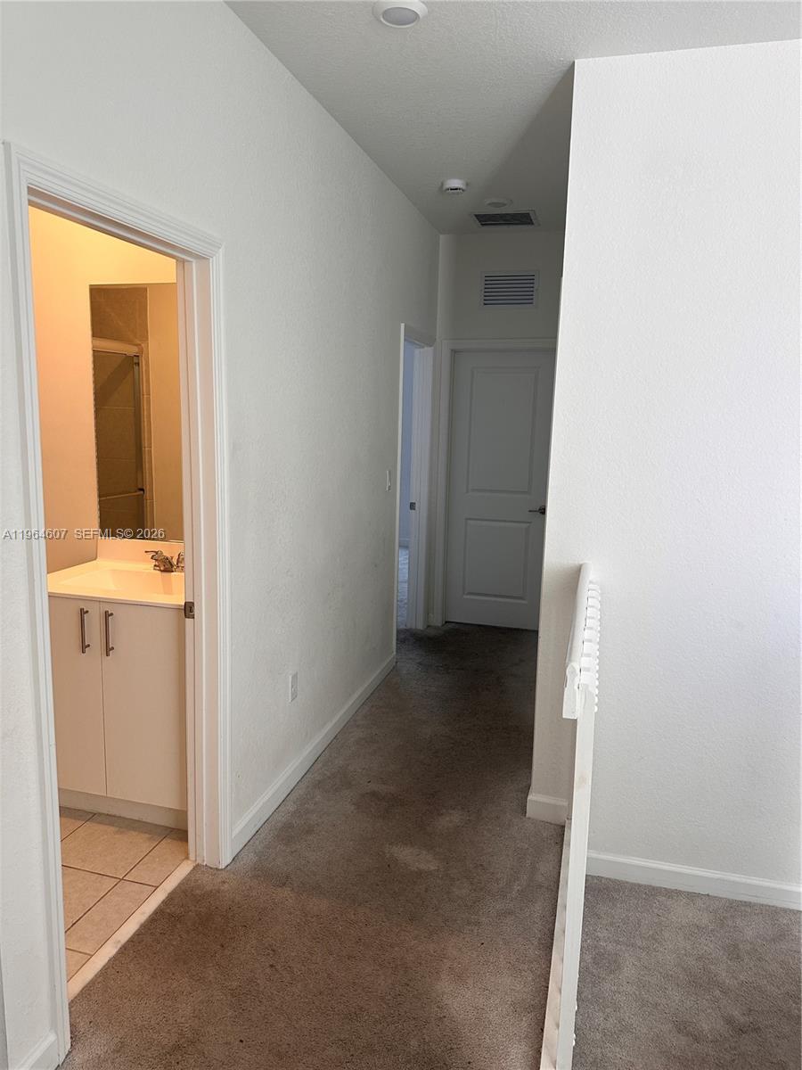 623 Southeast 13th St Circle Homestead, FL 33034 - Photo 11 of 28 a view of a hallway with closet