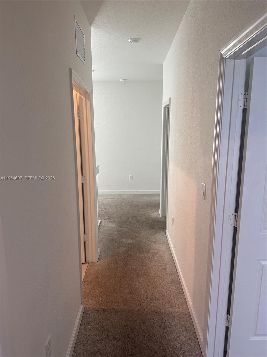 623 Southeast 13th St Circle Homestead, FL 33034 - Photo 13 of 28 a view of a hallway with wooden floor