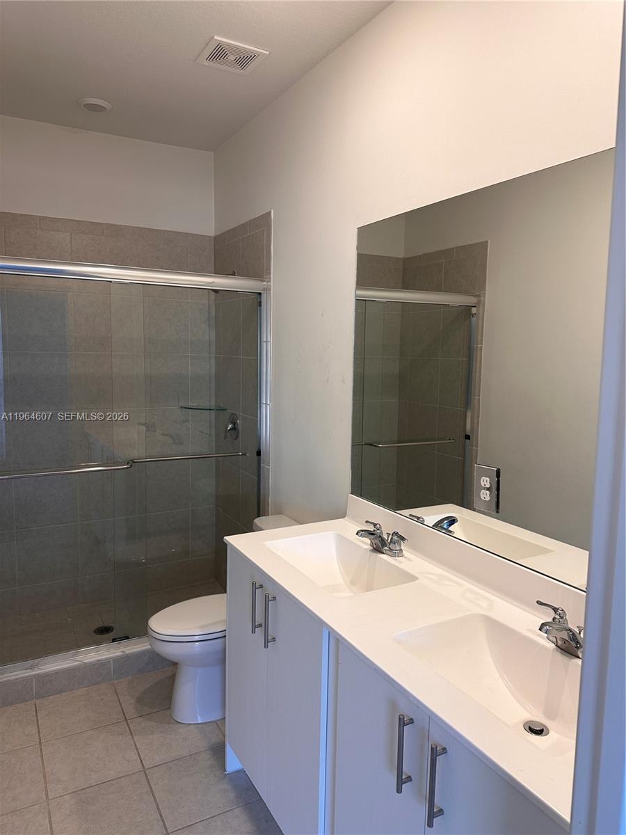 623 Southeast 13th St Circle Homestead, FL 33034 - Photo 19 of 28 a bathroom with a sink a toilet and shower