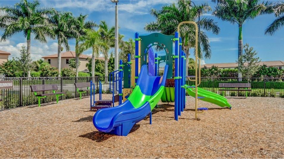 623 Southeast 13th St Circle Homestead, FL 33034 - Photo 26 of 28 a view of a park with slide and potted plants