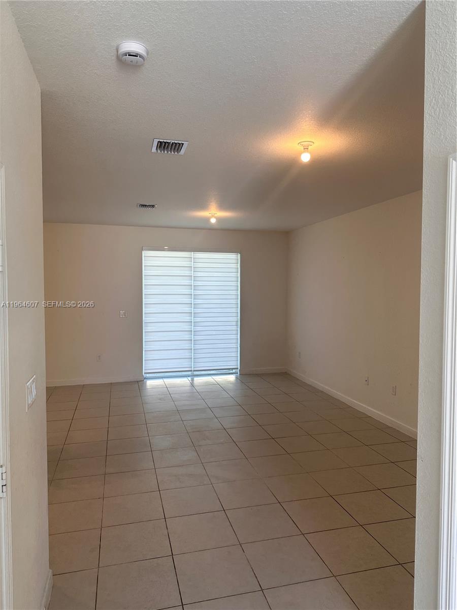 623 Southeast 13th St Circle Homestead, FL 33034 - Photo 3 of 28 a view of an empty room with a window