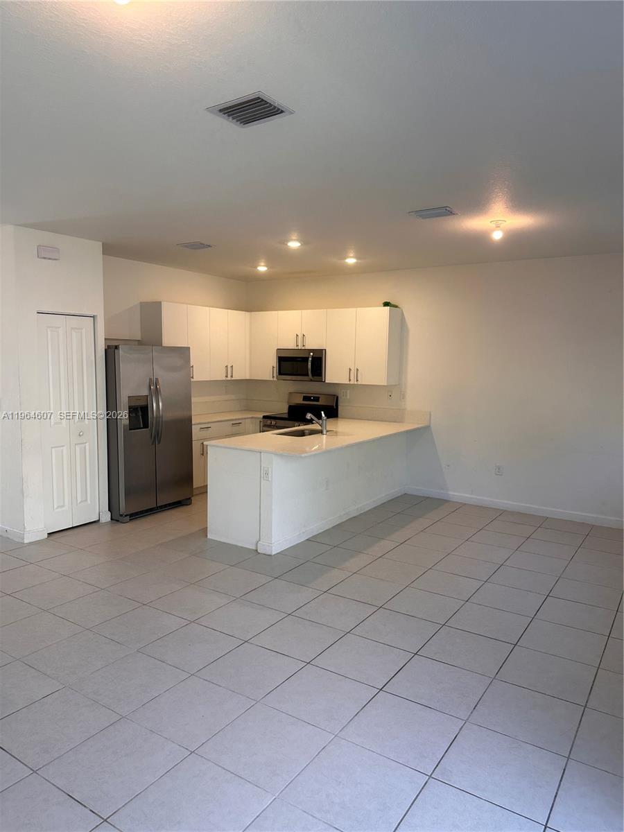 623 Southeast 13th St Circle Homestead, FL 33034 - Photo 5 of 28 a view of a kitchen with a sink and an oven