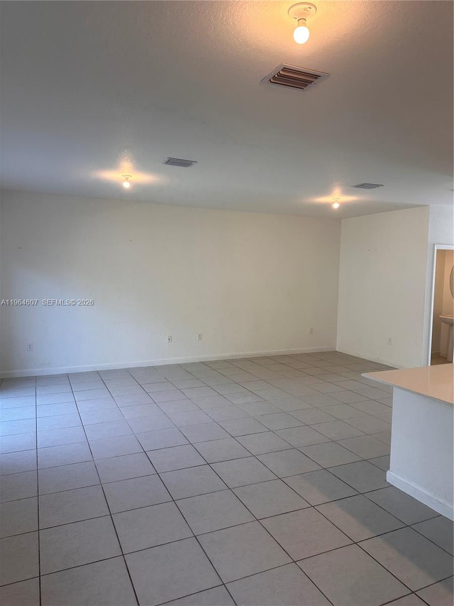 623 Southeast 13th St Circle Homestead, FL 33034 - Photo 6 of 28 an empty room with a bench