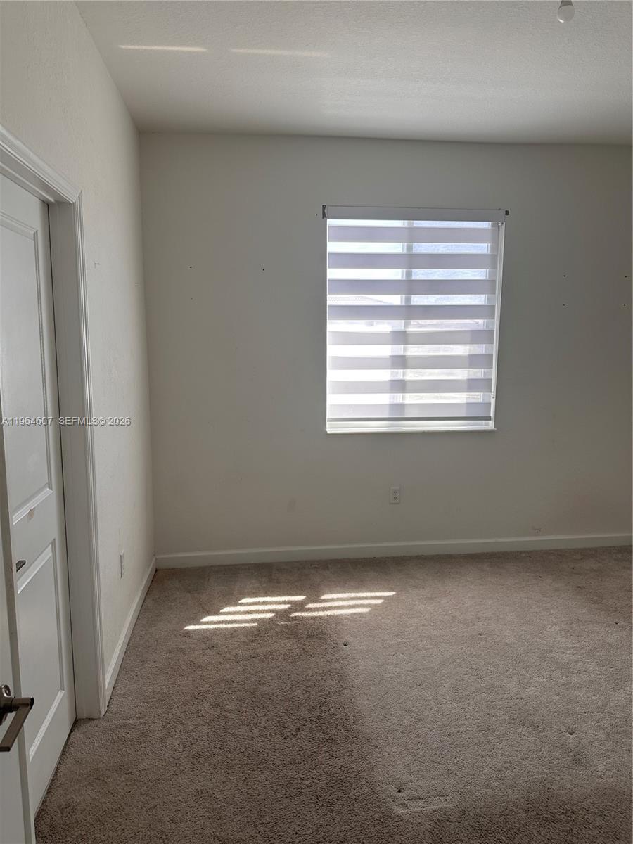 623 Southeast 13th St Circle Homestead, FL 33034 - Photo 7 of 28 an empty room with a window