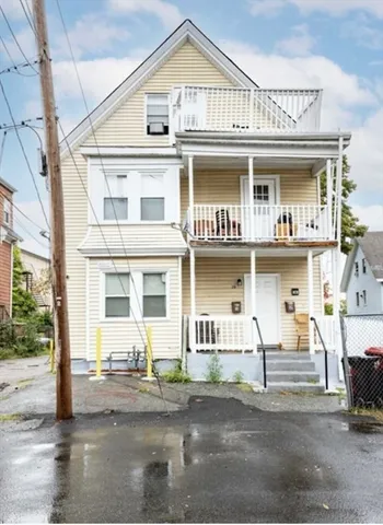 a front view of a residential apartment building with a yard