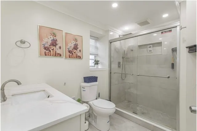 a bathroom with a sink toilet and shower