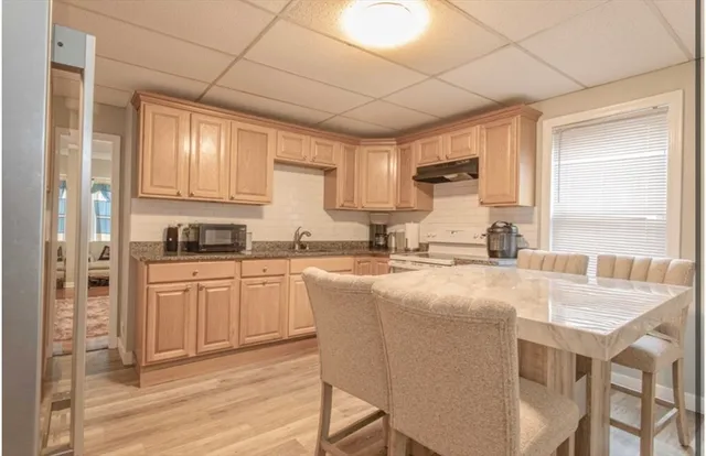 a kitchen with stainless steel appliances granite countertop a stove a sink dishwasher and a refrigerator