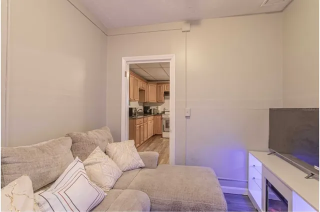 a bedroom with a bed and flat tv screen on the dresser
