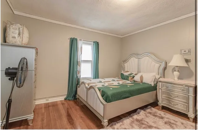 a bedroom with a bed and dresser