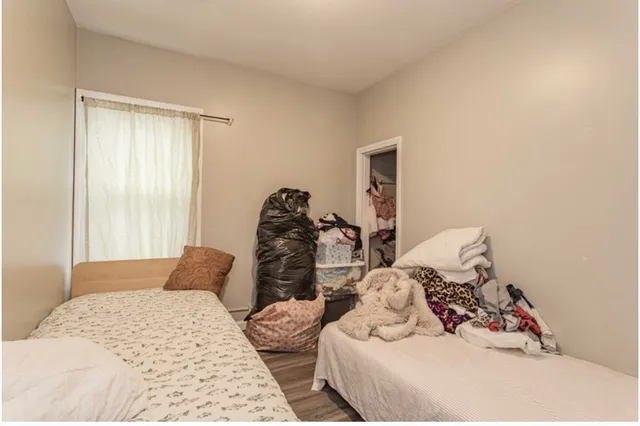 a bedroom with bed and a window