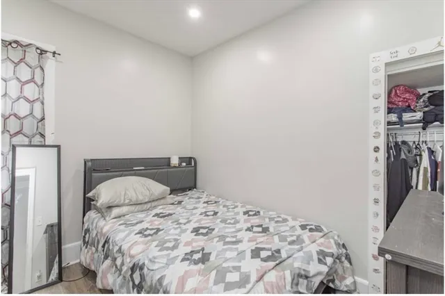 a bedroom with a bed and a painting on the wall