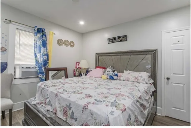 a bed sitting in a bedroom next to a window