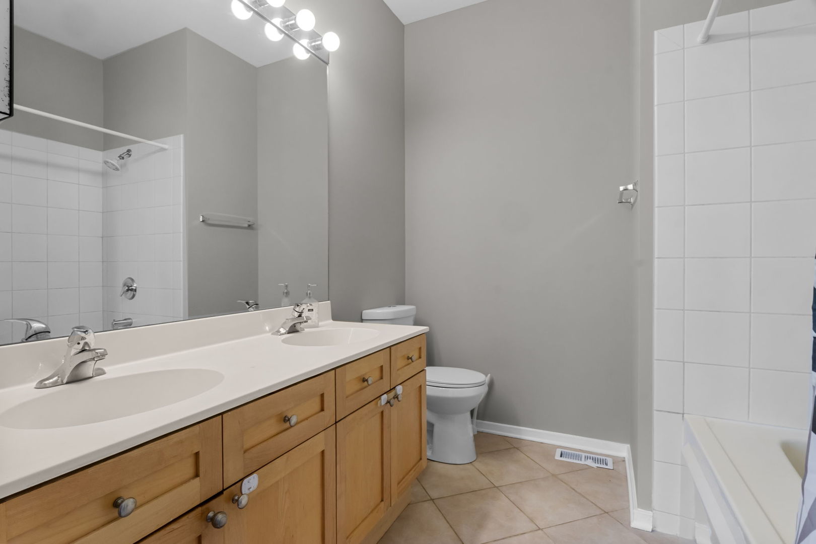 1616 South Indiana Avenue, Unit B3 Chicago, IL 60616 - Photo 18 of 32 a bathroom with a granite countertop sink a toilet and a mirror