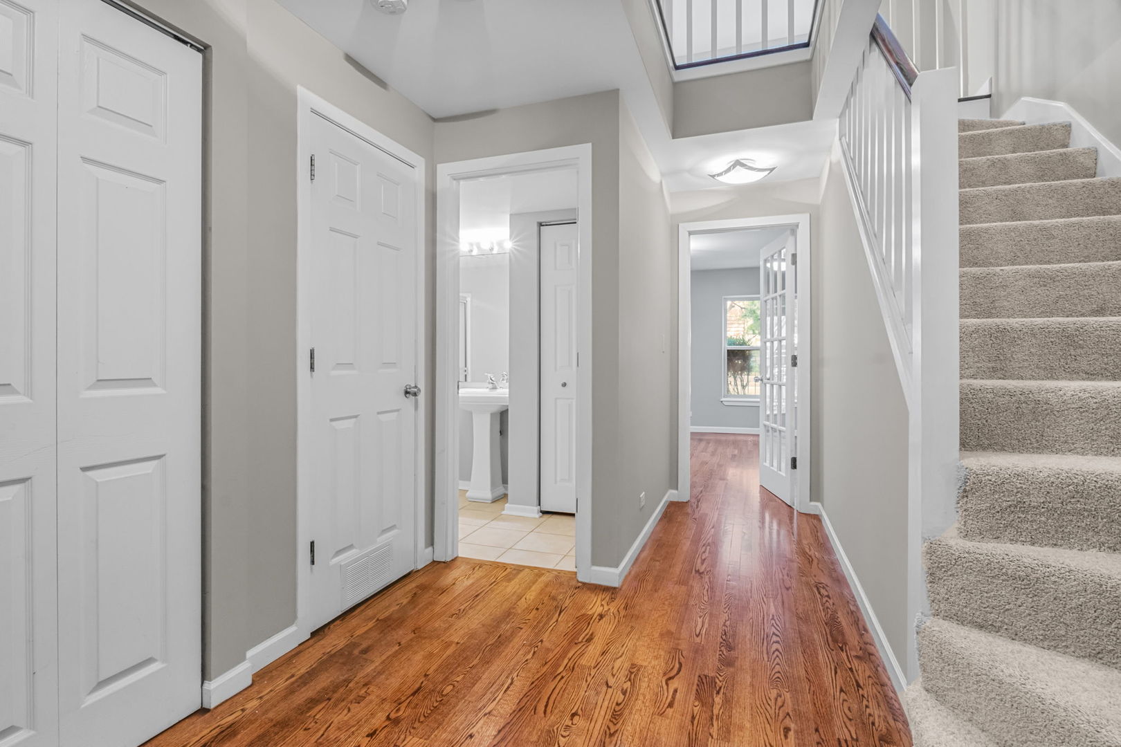 1616 South Indiana Avenue, Unit B3 Chicago, IL 60616 - Photo 19 of 32 a view of a hallway with wooden floor and a bathroom