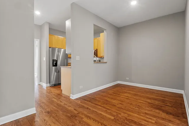 a view of a room with wooden floor and a window