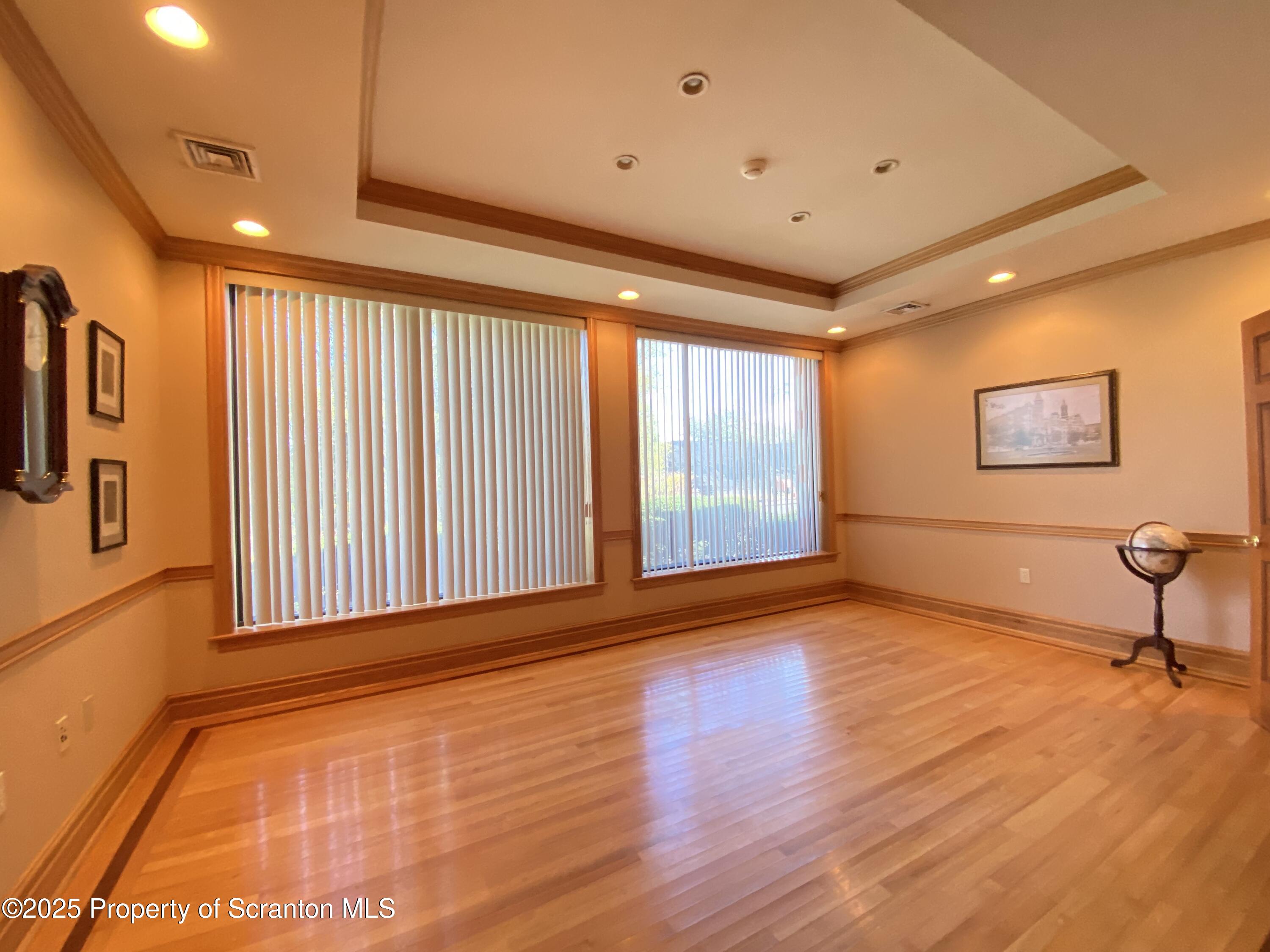 381 North 9th Avenue Scranton, PA 18504 - Photo 15 of 56 a view of an empty room with a window and wooden floor