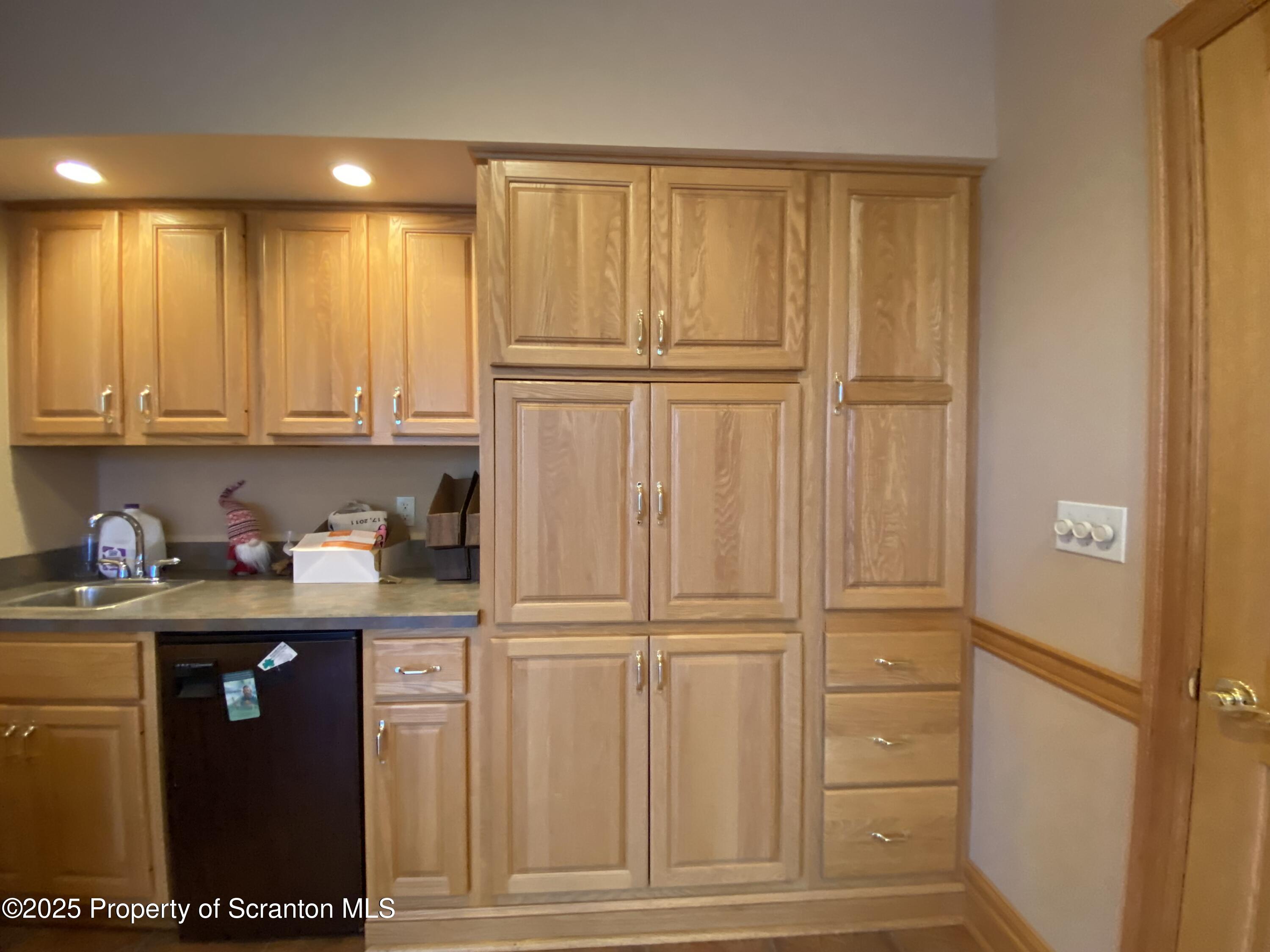 381 North 9th Avenue Scranton, PA 18504 - Photo 16 of 56 a kitchen with granite countertop cabinets and refrigerator