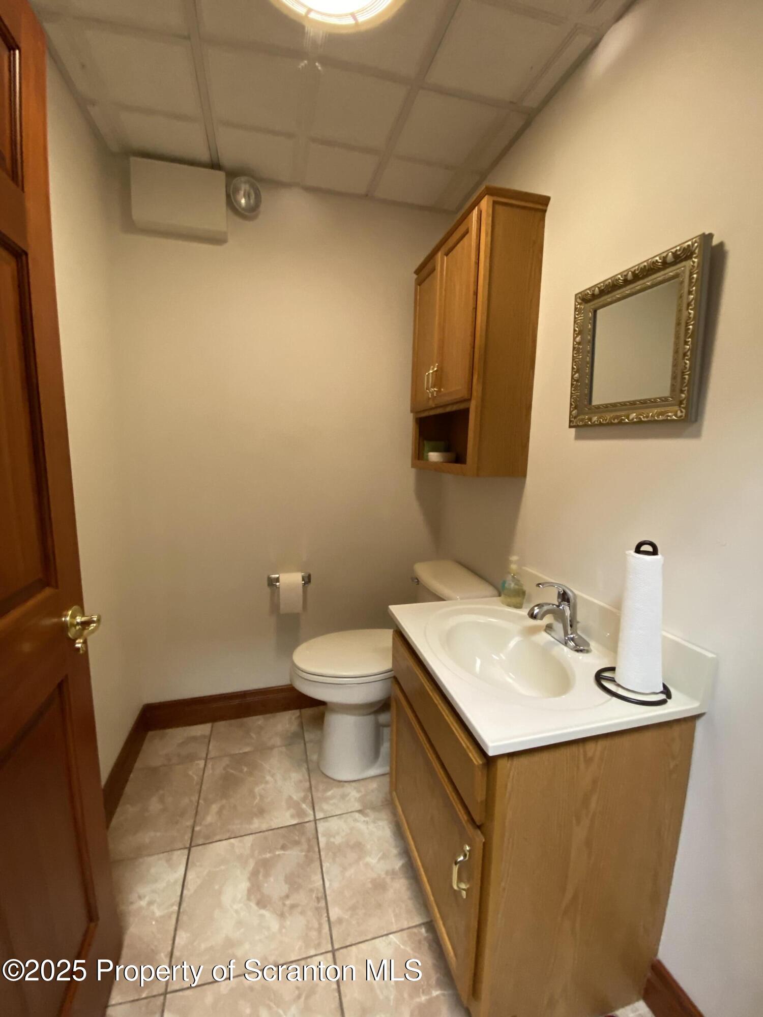 381 North 9th Avenue Scranton, PA 18504 - Photo 17 of 56 a bathroom with a sink a toilet and mirror