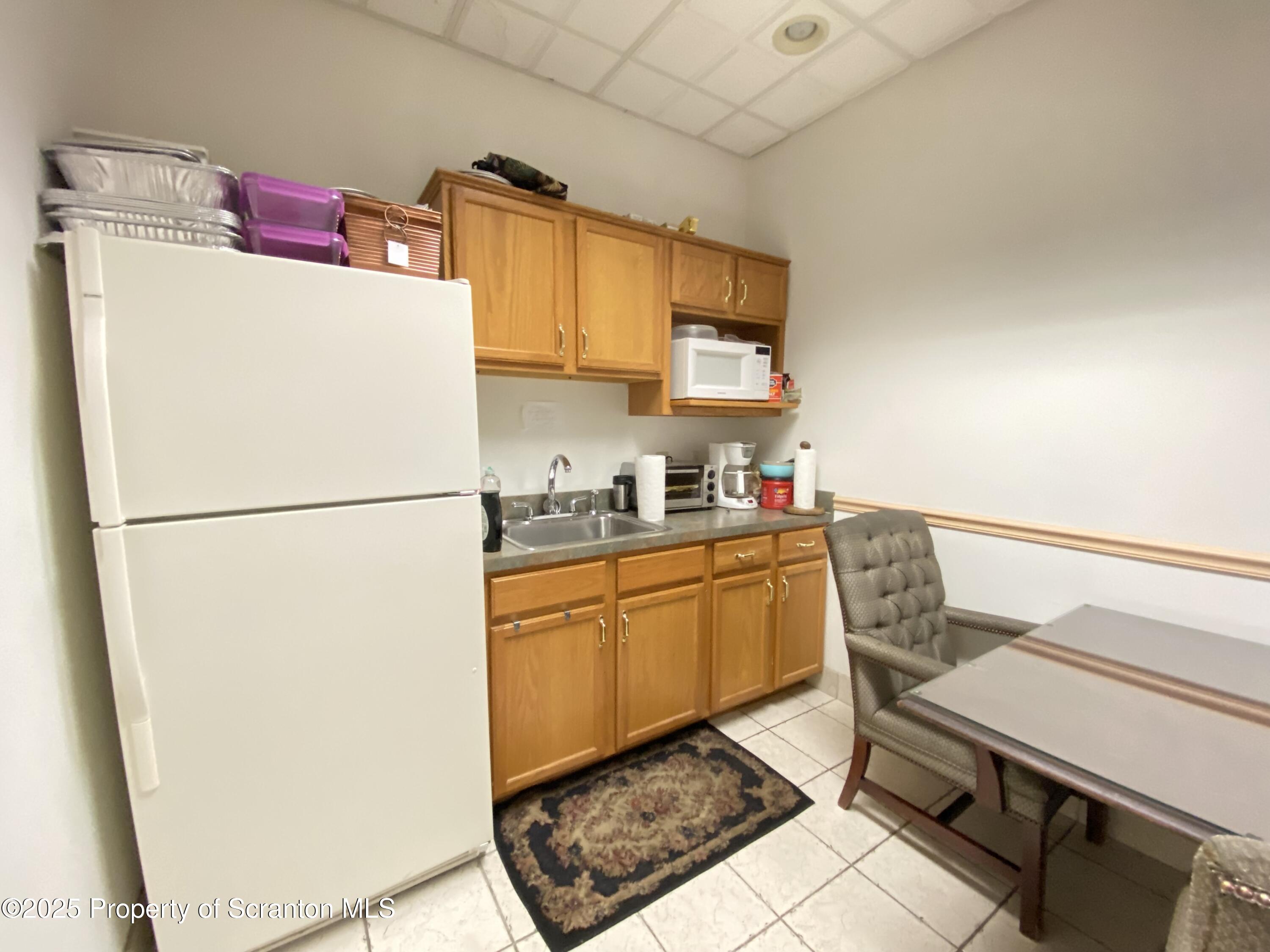 381 North 9th Avenue Scranton, PA 18504 - Photo 21 of 56 a living room with a couch and a refrigerator
