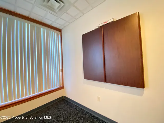 a view of a hallway with wooden floor and entryway