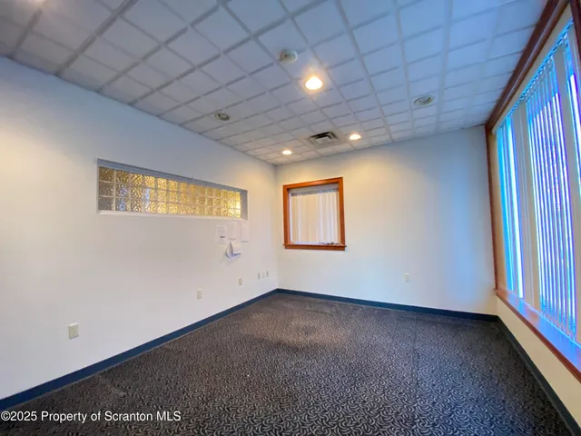 a living room with furniture and a table with wooden floor
