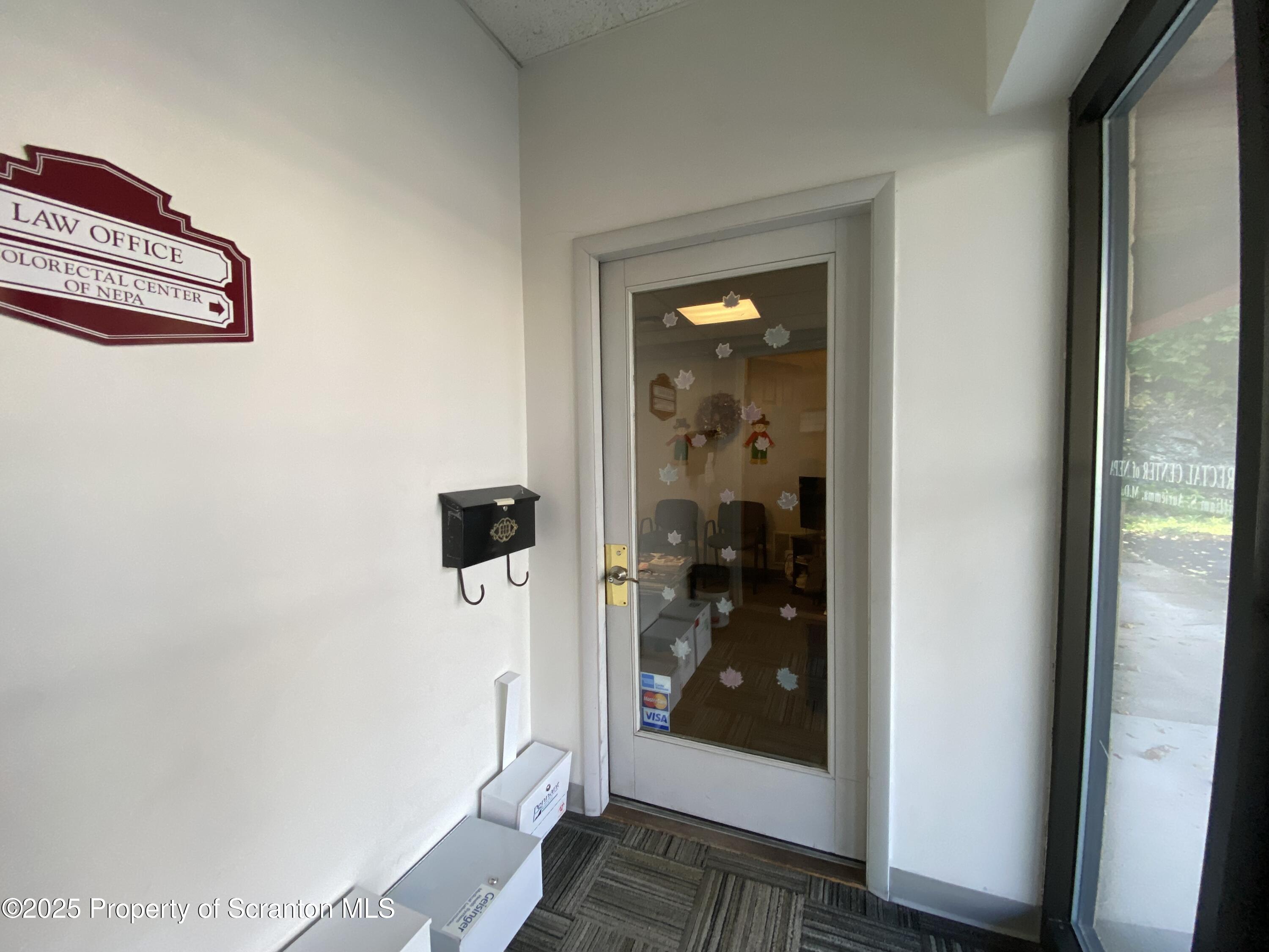 381 North 9th Avenue Scranton, PA 18504 - Photo 33 of 56 a view of a hallway with wooden floor and a living room