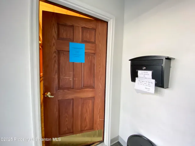 a living room with furniture and a dining table with wooden floor