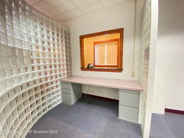 a view of an empty room with empty shelves