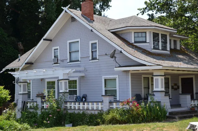 a front view of a house with garden
