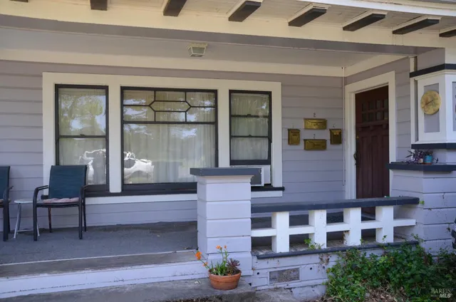 a living room with furniture and large windows