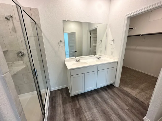 a bathroom with a double vanity sink and mirror