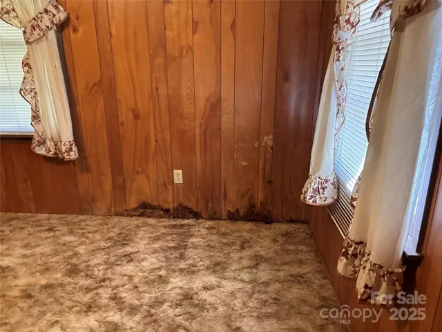 a view of door with wooden walls