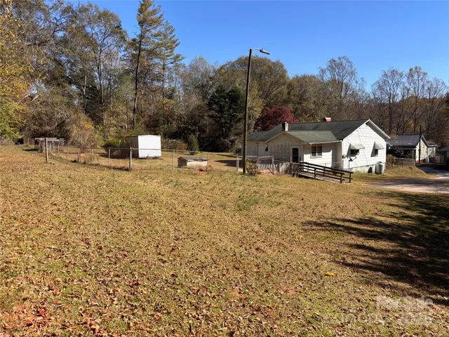 a view of a house with a yard and trees