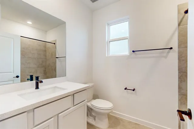a bathroom with a sink a toilet and mirror