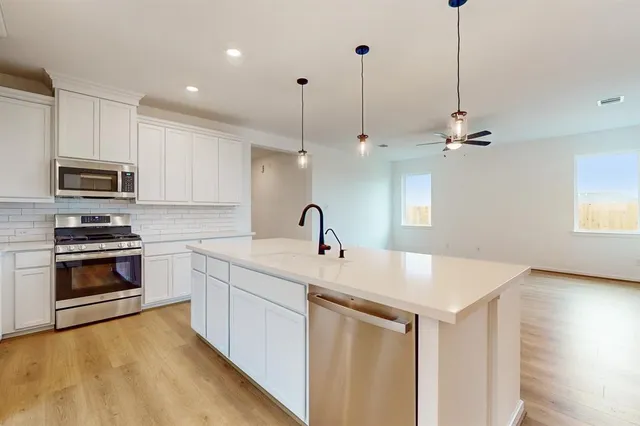 a kitchen with sink a microwave and stove