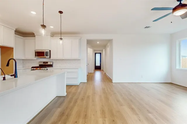a view of kitchen with sink microwave and stove