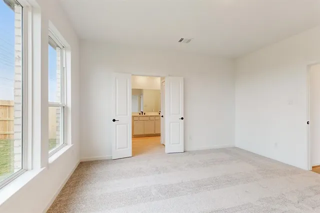 a view of an empty room and a window
