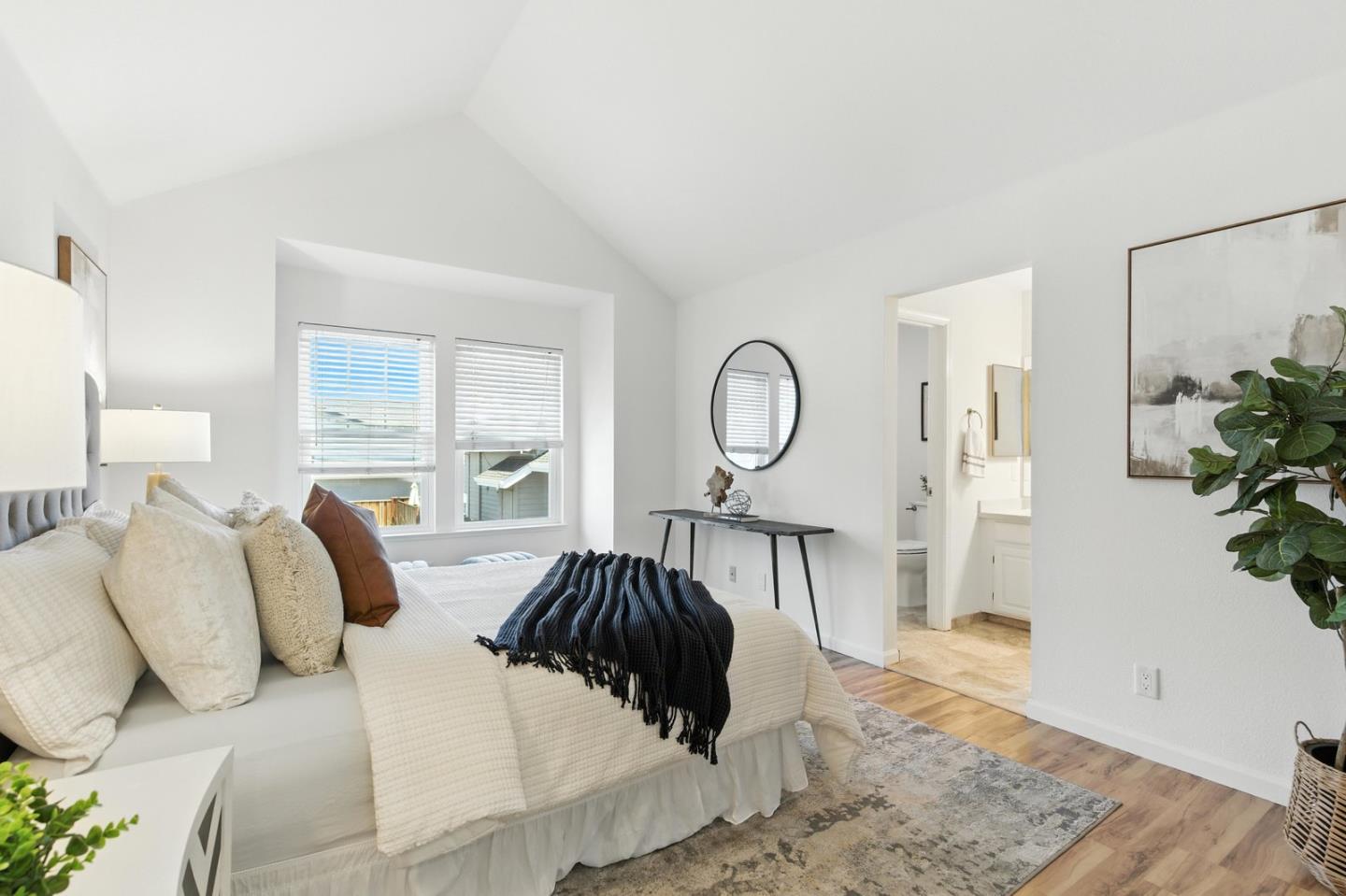 113 East Rincon Avenue Campbell, CA 95008 - Photo 12 of 26 a bedroom with a large bed and a potted plant