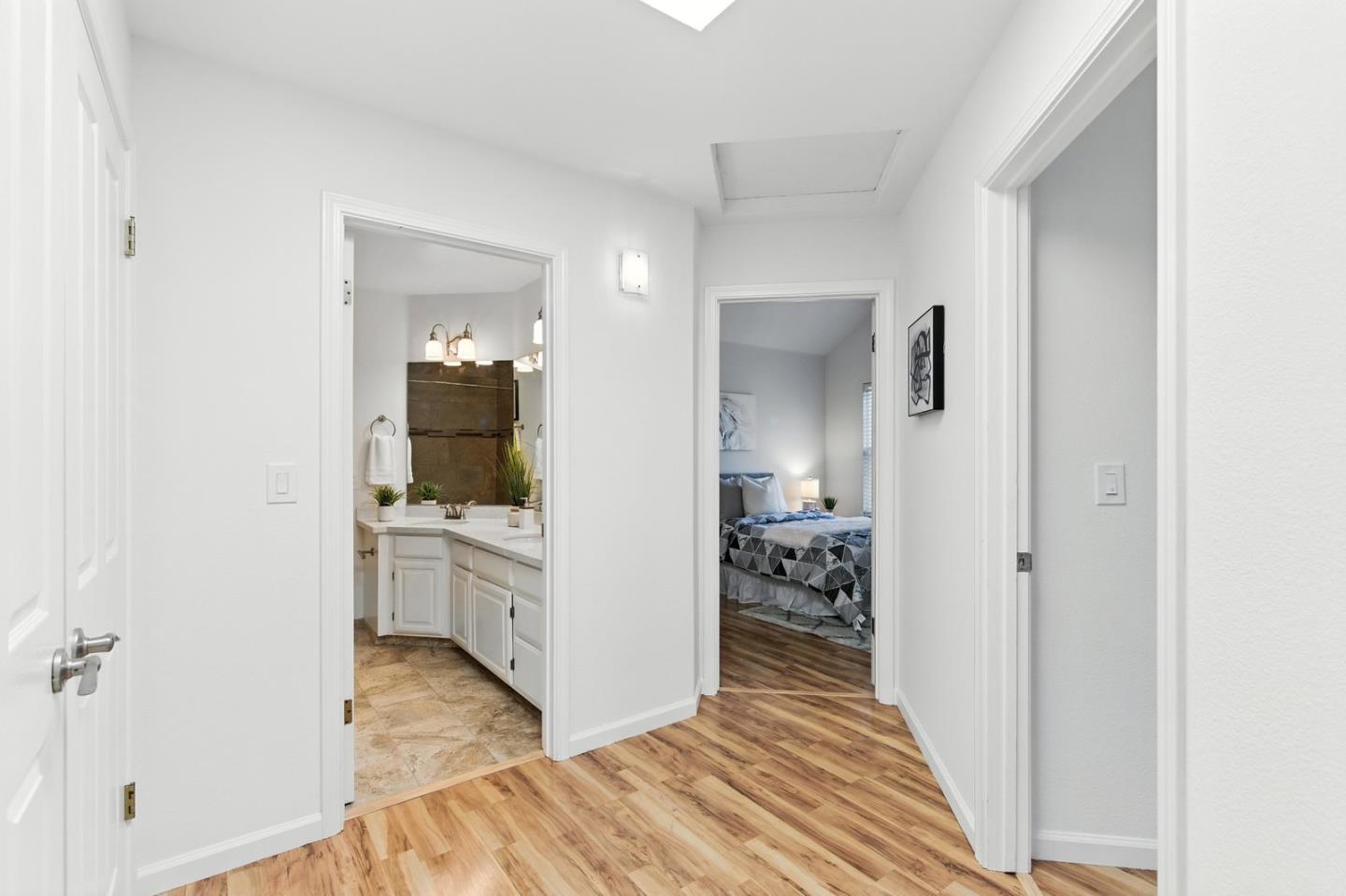 113 East Rincon Avenue Campbell, CA 95008 - Photo 17 of 26 a view of a hallway with bathroom and wooden floor