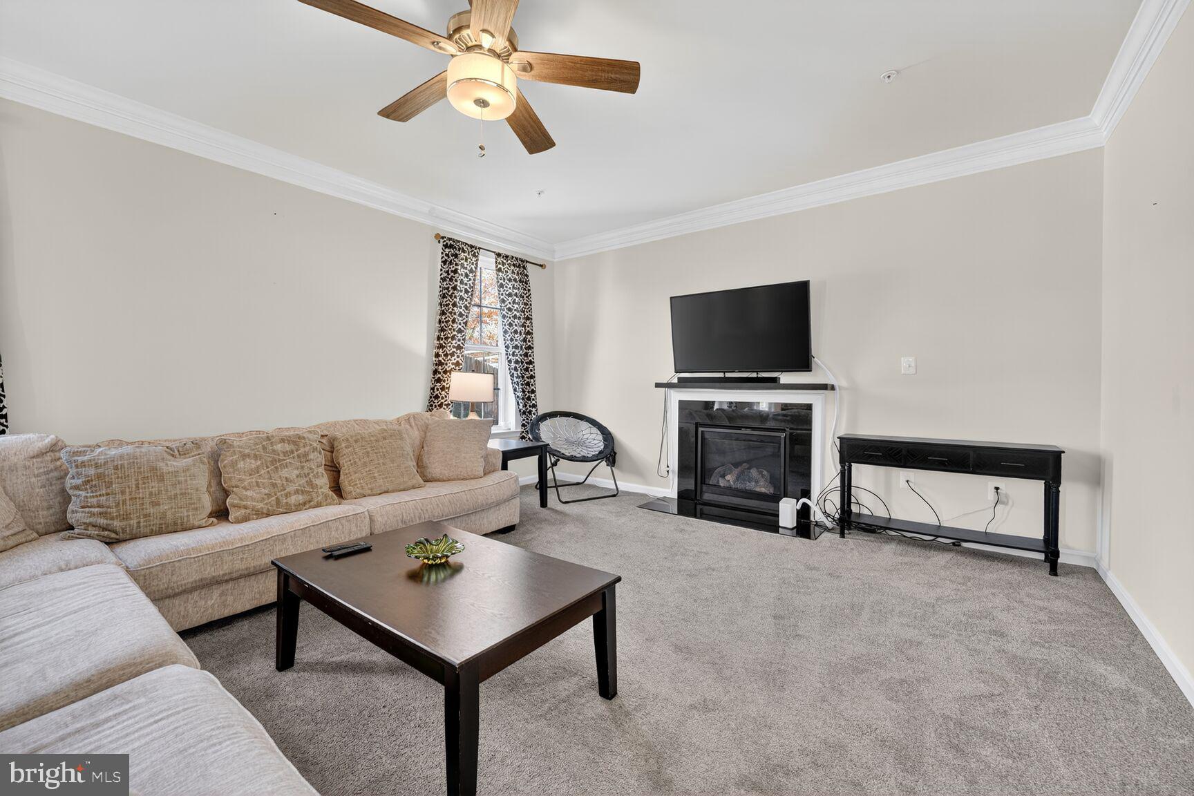 711 Yarrow Court Accokeek, MD 20607 - Photo 12 of 40 a living room with furniture a fireplace and a flat screen tv