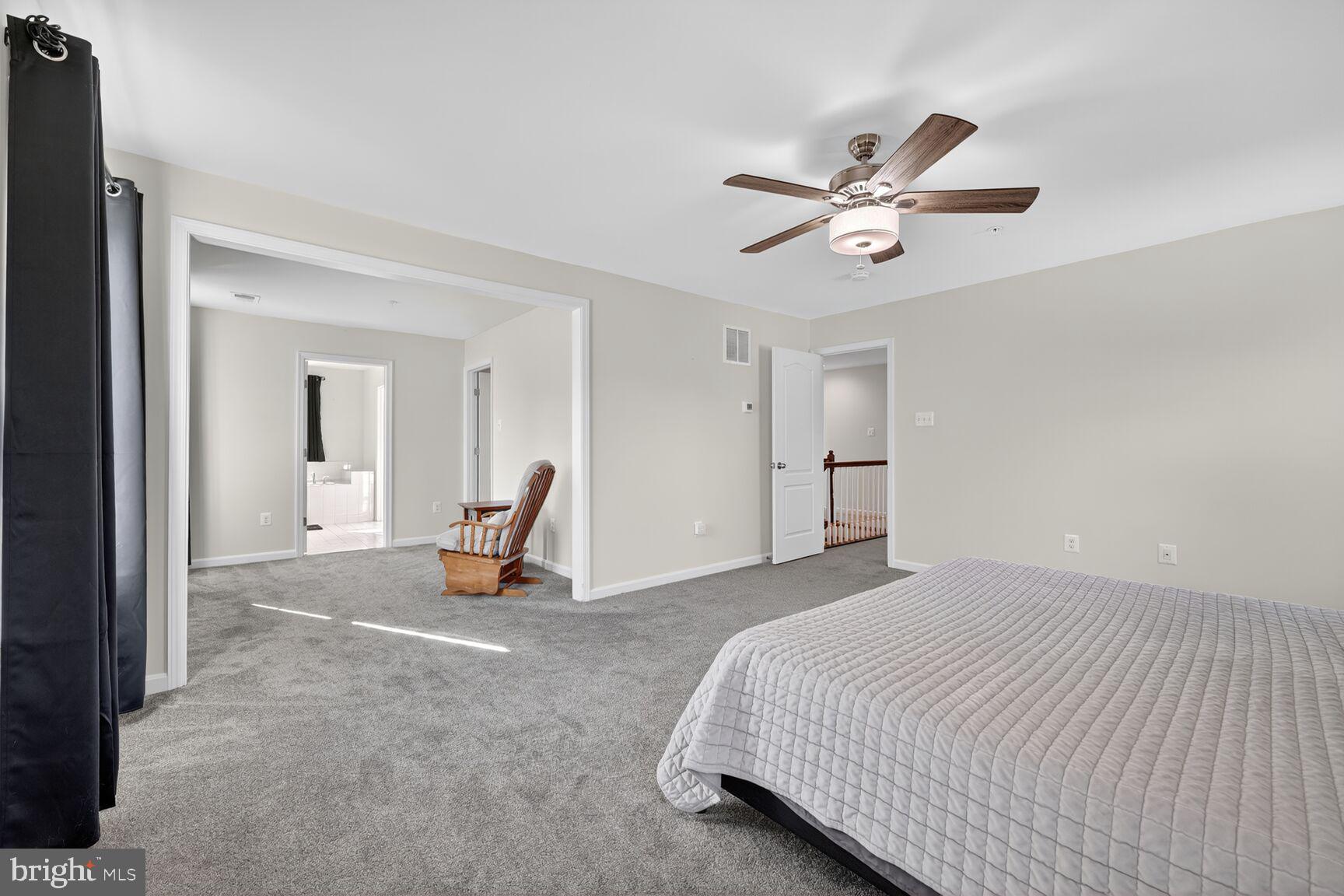 711 Yarrow Court Accokeek, MD 20607 - Photo 17 of 40 a bedroom with a bed and a chandelier