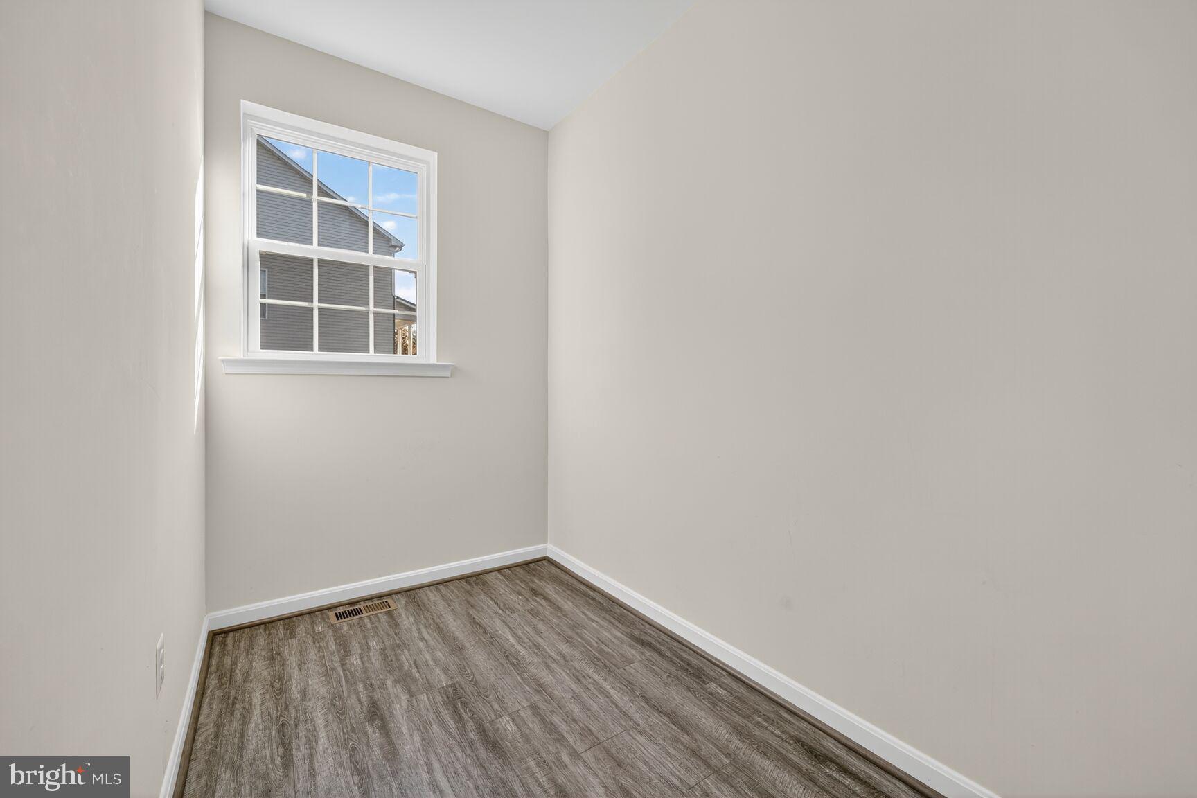 711 Yarrow Court Accokeek, MD 20607 - Photo 28 of 40 a view of an empty room with wooden floor and a window