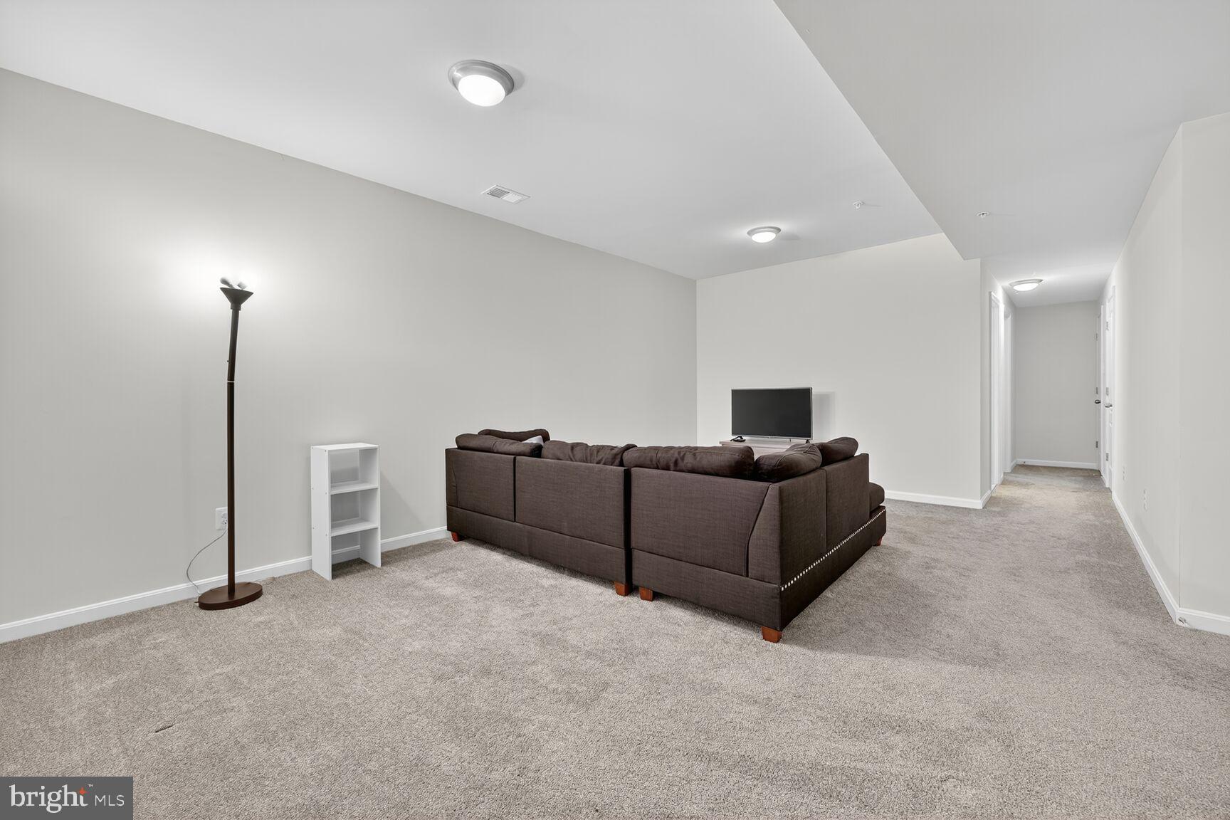 711 Yarrow Court Accokeek, MD 20607 - Photo 30 of 40 a living room with furniture and a wooden floor