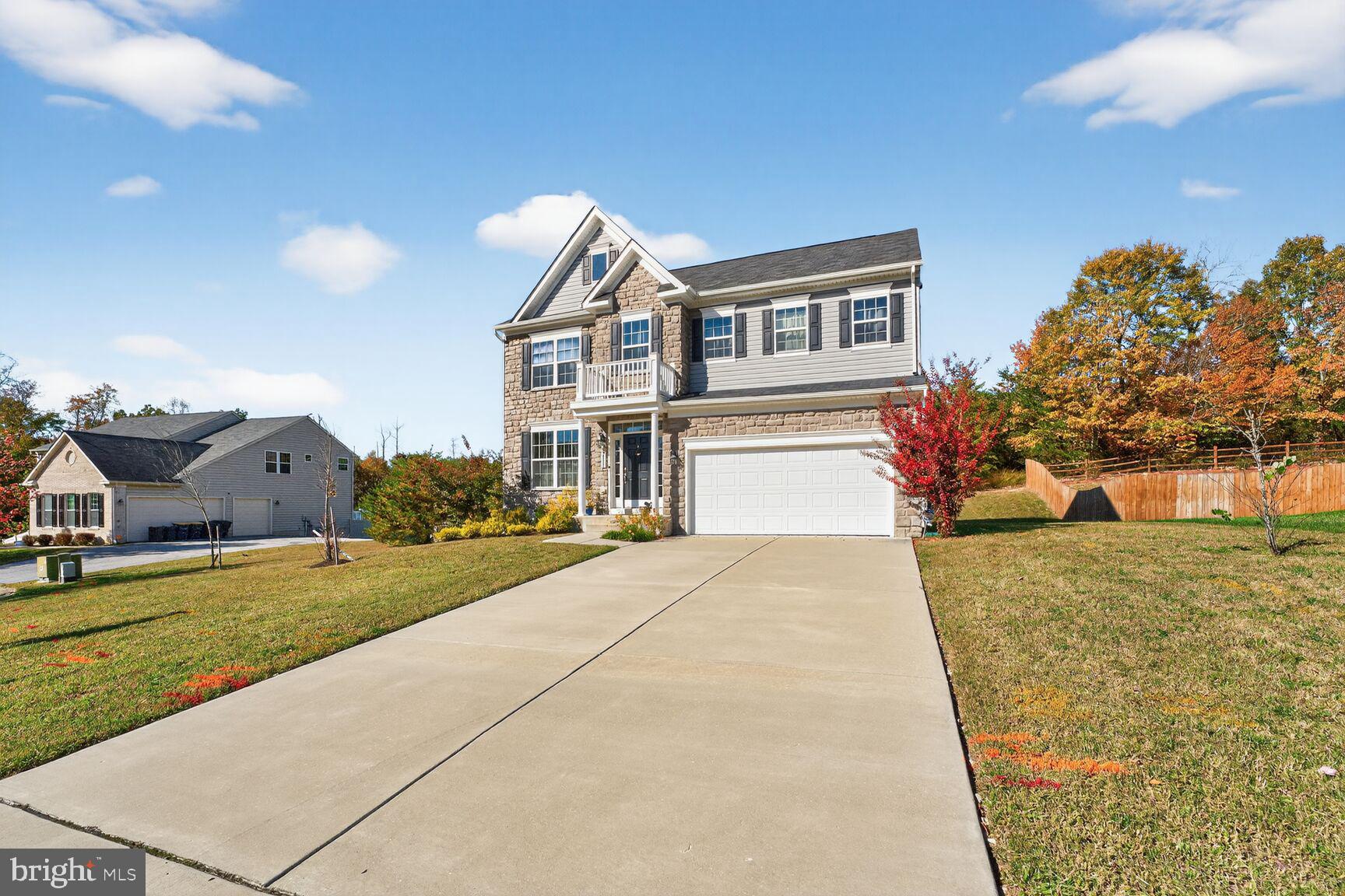 711 Yarrow Court Accokeek, MD 20607 - Photo 4 of 40 a front view of a house with a yard and garage
