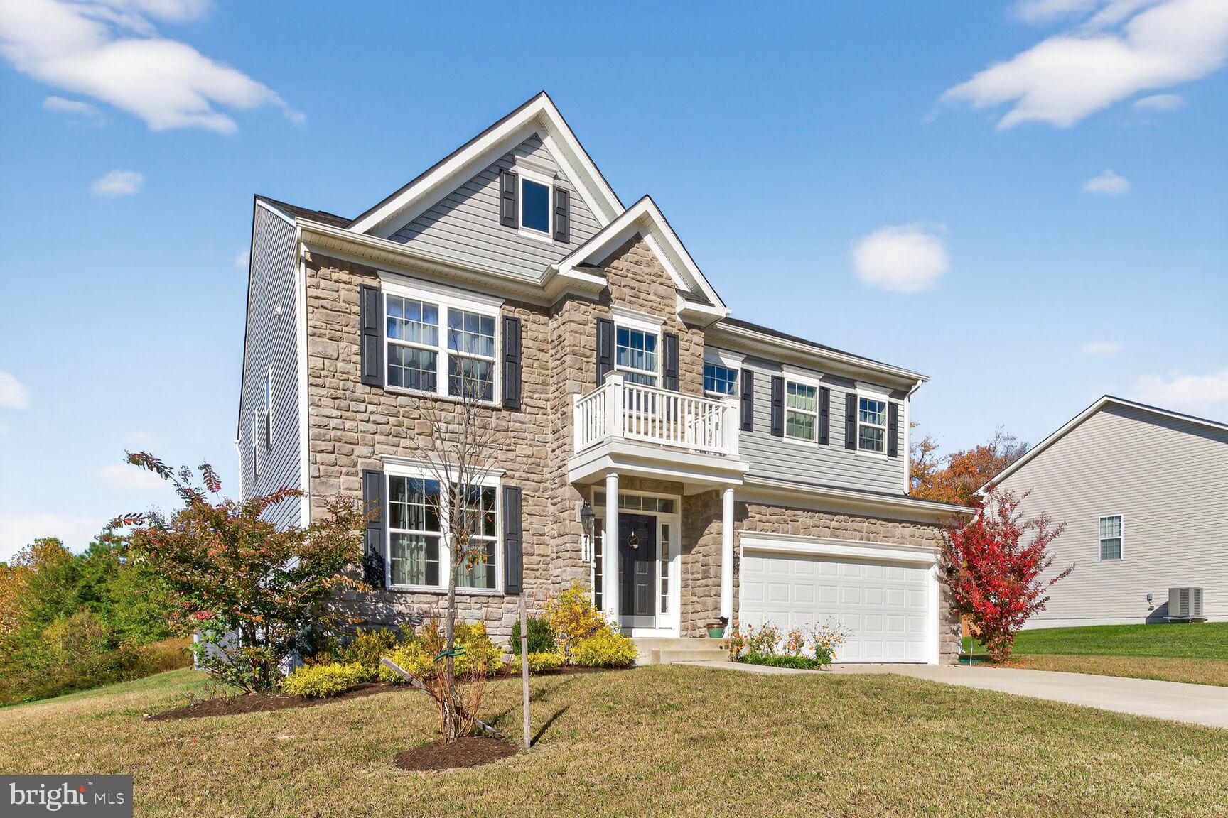 711 Yarrow Court Accokeek, MD 20607 - Photo 5 of 40 a front view of a house with a yard and garage