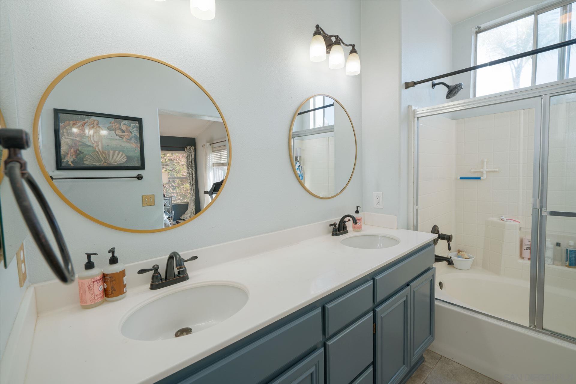 3396 Monique Lane Spring Valley, CA 91977 - Photo 13 of 31 a bathroom with a sink and a mirror