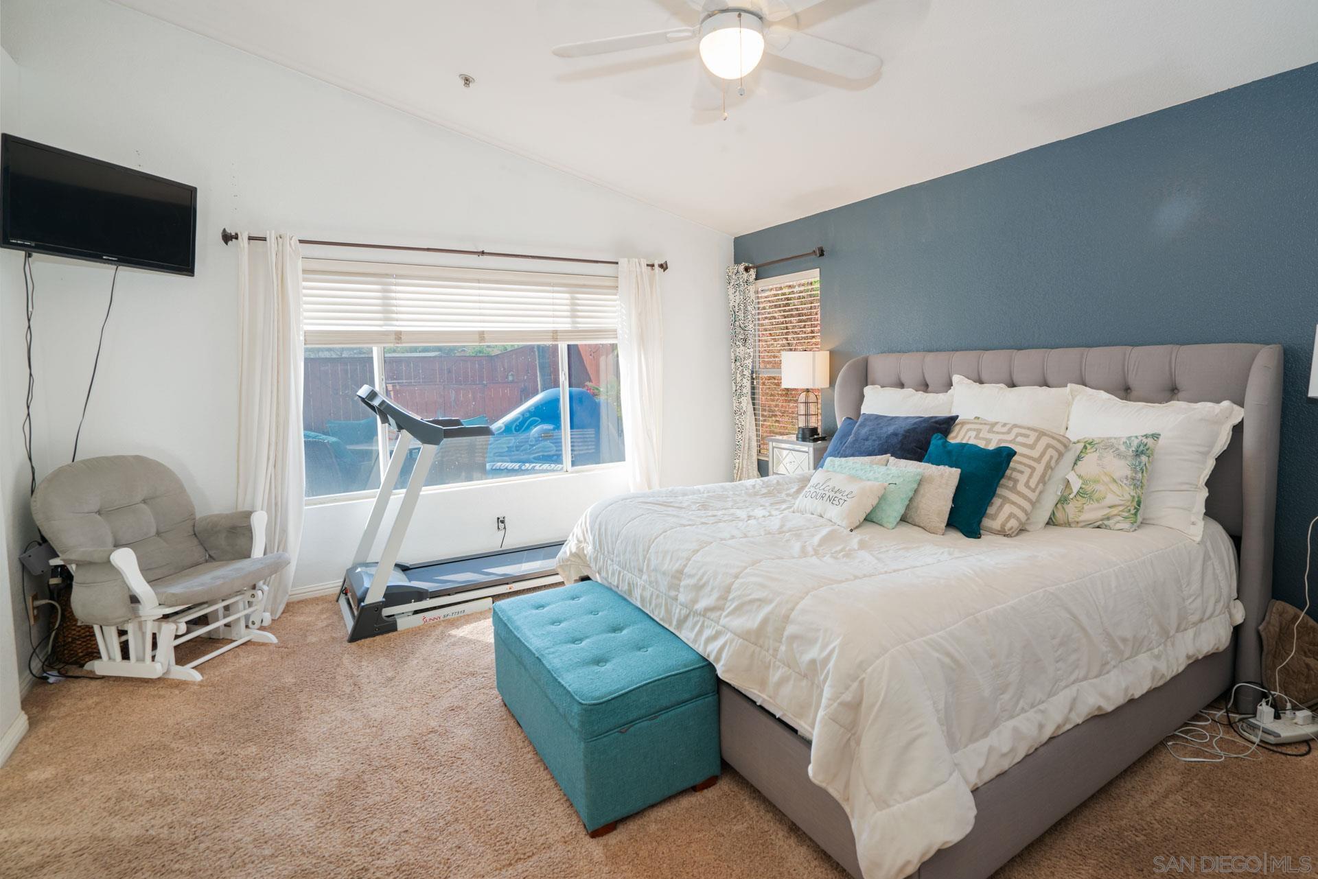 3396 Monique Lane Spring Valley, CA 91977 - Photo 15 of 31 a bedroom with a bed a flat screen tv and a large window