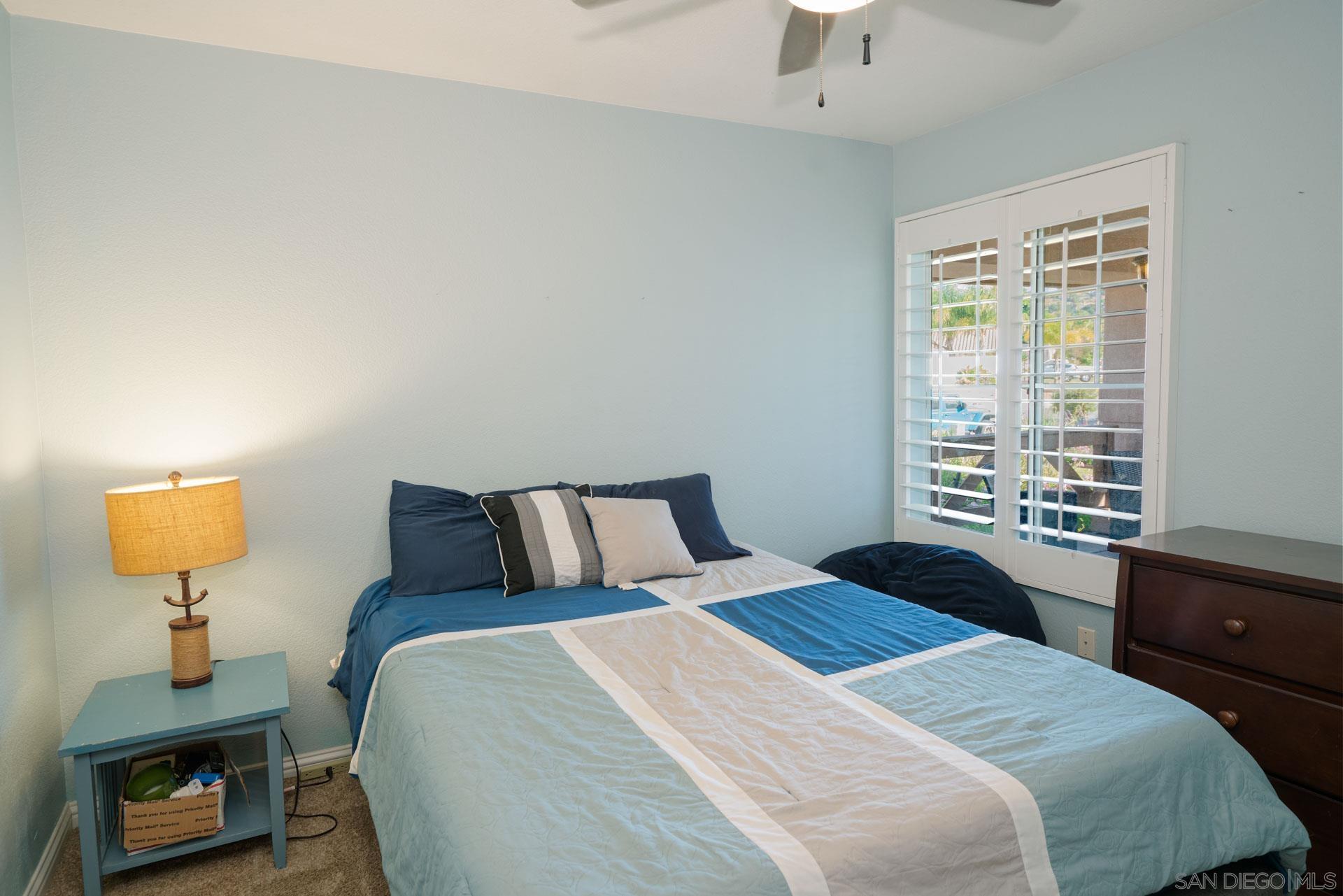 3396 Monique Lane Spring Valley, CA 91977 - Photo 19 of 31 a bedroom with a bed and a window