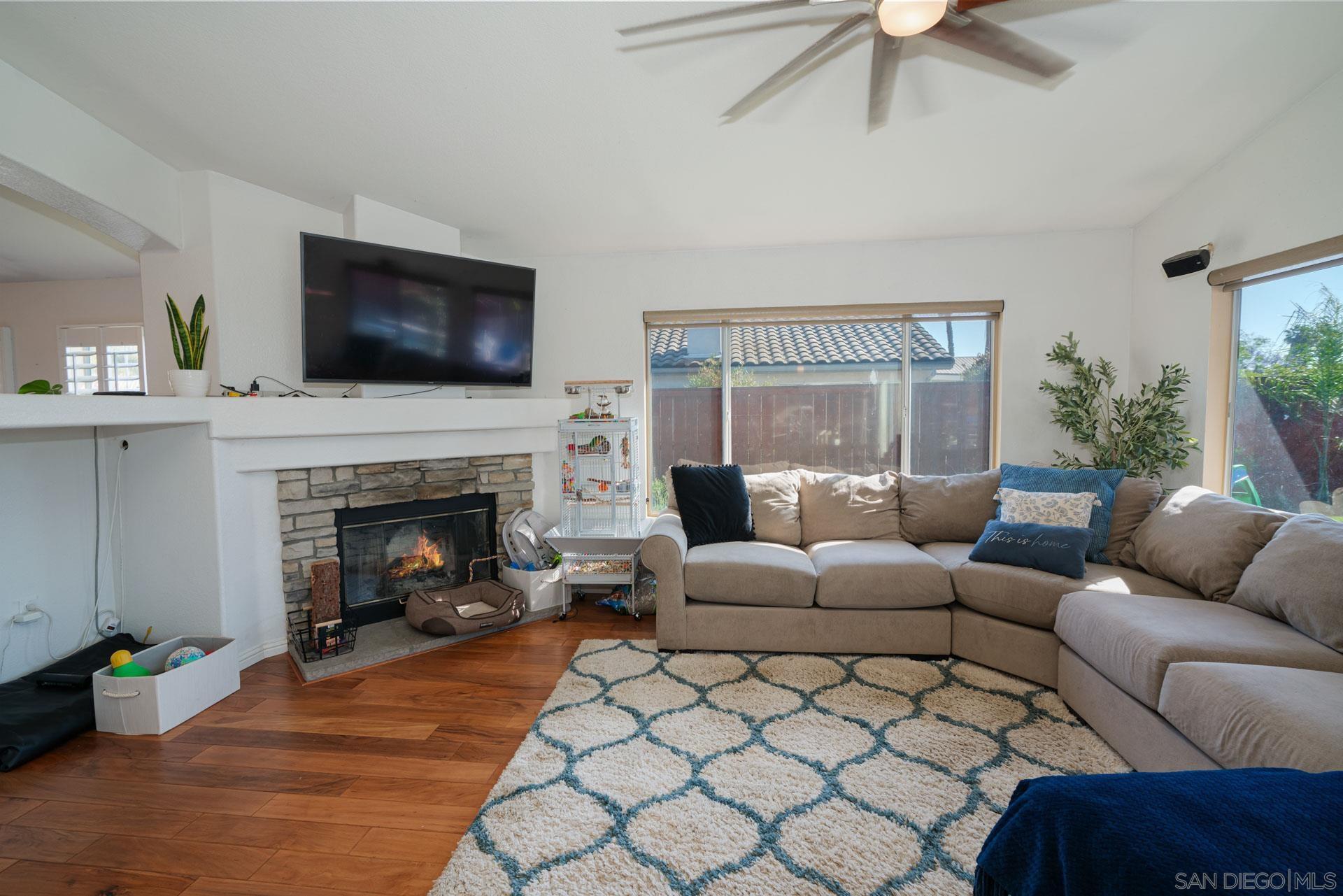3396 Monique Lane Spring Valley, CA 91977 - Photo 2 of 31 a living room with furniture a flat screen tv and a fireplace
